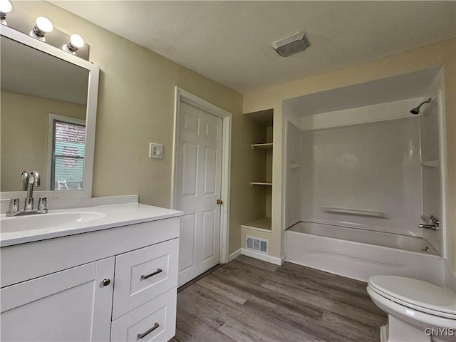 11 Bryant St, Utica, NY 13502 - bathroom featuring vanity, wood finished floors, toilet, and washtub / shower combination