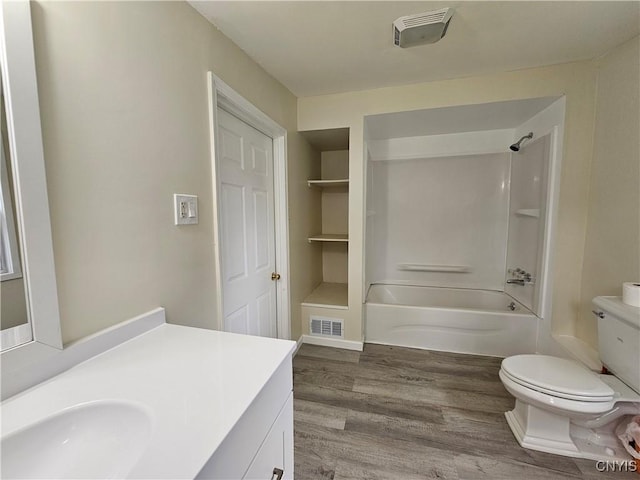 11 Bryant St, Utica, NY 13502 - bathroom with vanity, toilet, wood finished floors, and shower / bathtub combination
