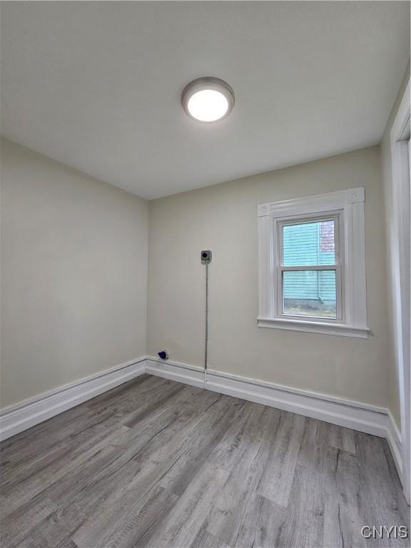 11 Bryant St, Utica, NY 13502 - unfurnished room featuring wood finished floors and baseboards