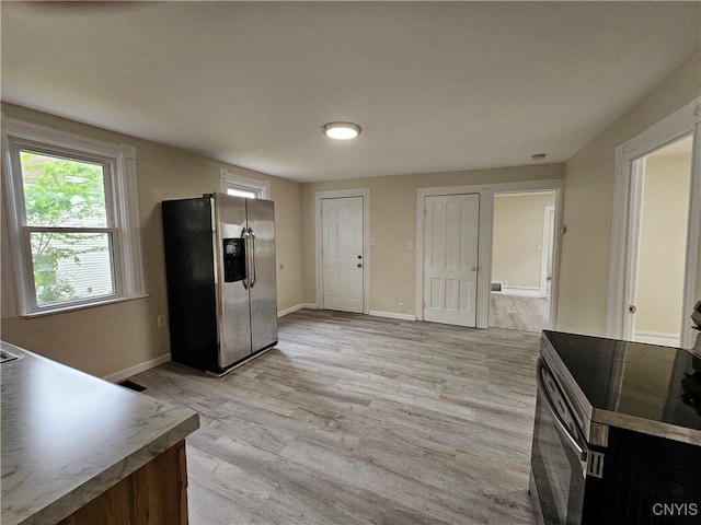 11 Bryant St, Utica, NY 13502 - kitchen featuring appliances with stainless steel finishes, light wood-style floors, and baseboards