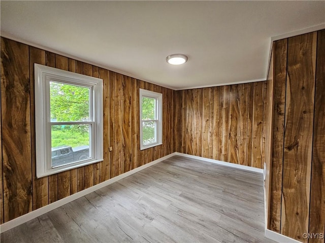 11 Bryant St, Utica, NY 13502 - unfurnished room with wood finished floors, baseboards, and wood walls