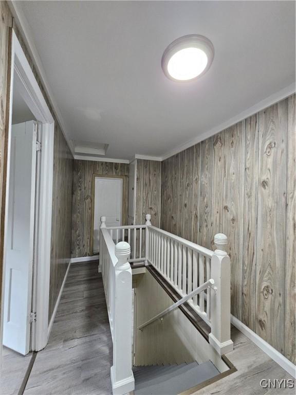 11 Bryant St, Utica, NY 13502 - staircase with wood finished floors, wood walls, attic access, and baseboards