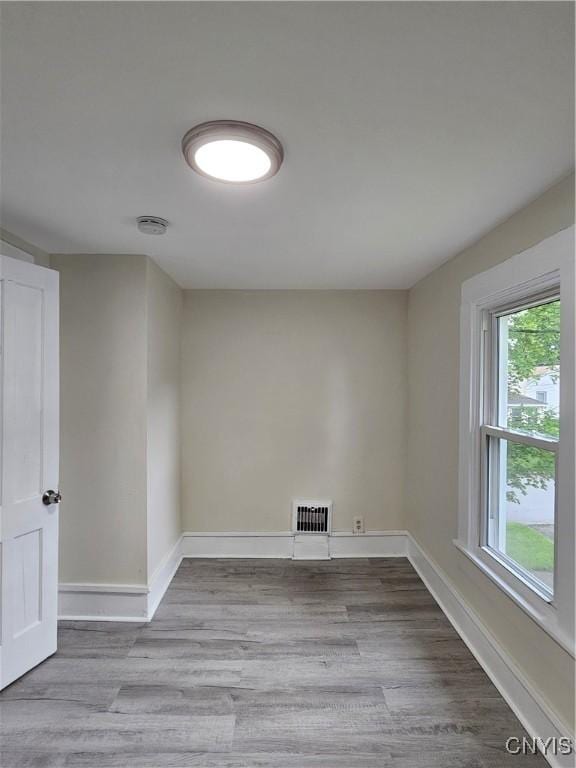 11 Bryant St, Utica, NY 13502 - unfurnished room featuring baseboards, wood finished floors, and a smoke detector