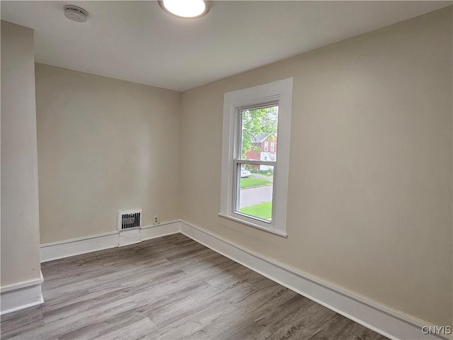 11 Bryant St, Utica, NY 13502 - spare room with a smoke detector, dark wood finished floors, and baseboards