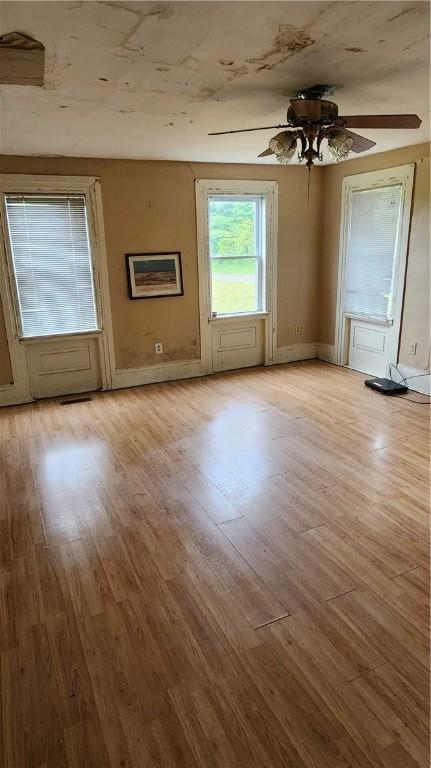 7978 Tuttle Rd, Prattsburgh, NY 14873 - unfurnished living room with wood finished floors, baseboards, and a ceiling fan
