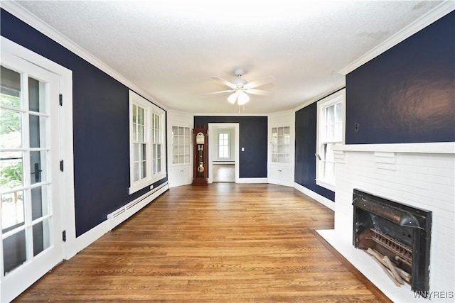 5002 Armor Duells Rd, Orchard Park, NY 14127 - entryway featuring a baseboard heating unit, ornamental molding, a brick fireplace, a ceiling fan, and wood finished floors