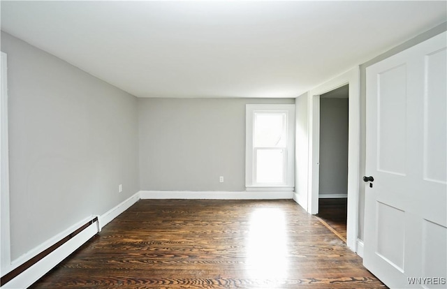 5002 Armor Duells Rd, Orchard Park, NY 14127 - spare room with a baseboard heating unit, dark wood-type flooring, and baseboards