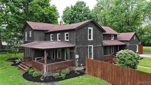5002 Armor Duells Rd, Orchard Park, NY 14127 - rear view of house featuring a shingled roof, a porch, and a chimney