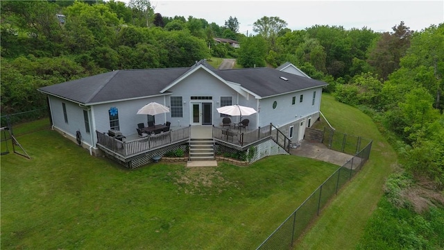 490 Bennett Pkwy, Hornellsville, NY 14843 - rear view of property featuring a deck, a garage, a fenced backyard, driveway, and a wooded view