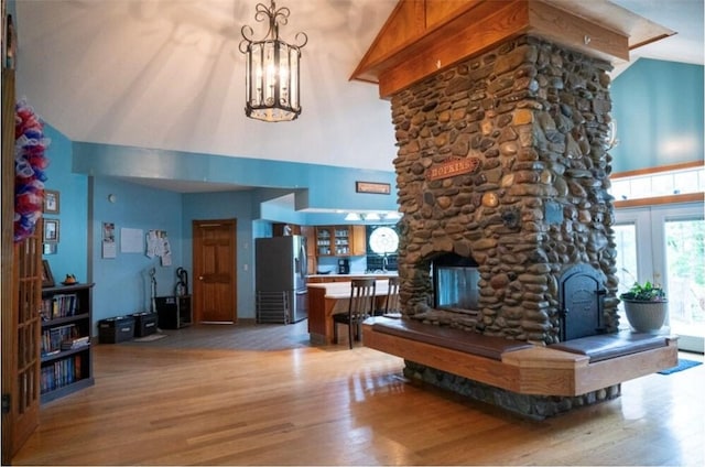 490 Bennett Pkwy, Hornellsville, NY 14843 - living room featuring high vaulted ceiling, wood finished floors, a fireplace, and a chandelier