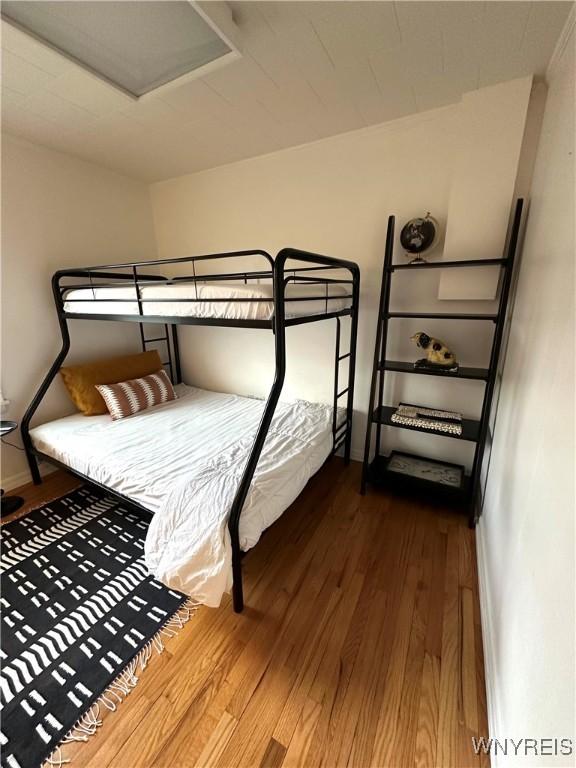 34 Maple St, Ellery, NY 14712 - bedroom featuring wood finished floors and attic access