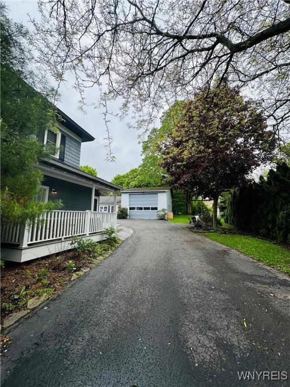 34 Maple St, Ellery, NY 14712 - view of property exterior featuring an outbuilding, a detached garage, and covered porch