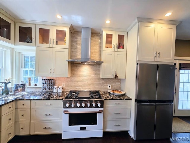 34 Maple St, Ellery, NY 14712 - kitchen featuring gas range, freestanding refrigerator, wall chimney exhaust hood, dark stone countertops, and white cabinetry