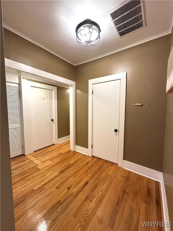 34 Maple St, Ellery, NY 14712 - empty room featuring crown molding, light wood finished floors, and baseboards