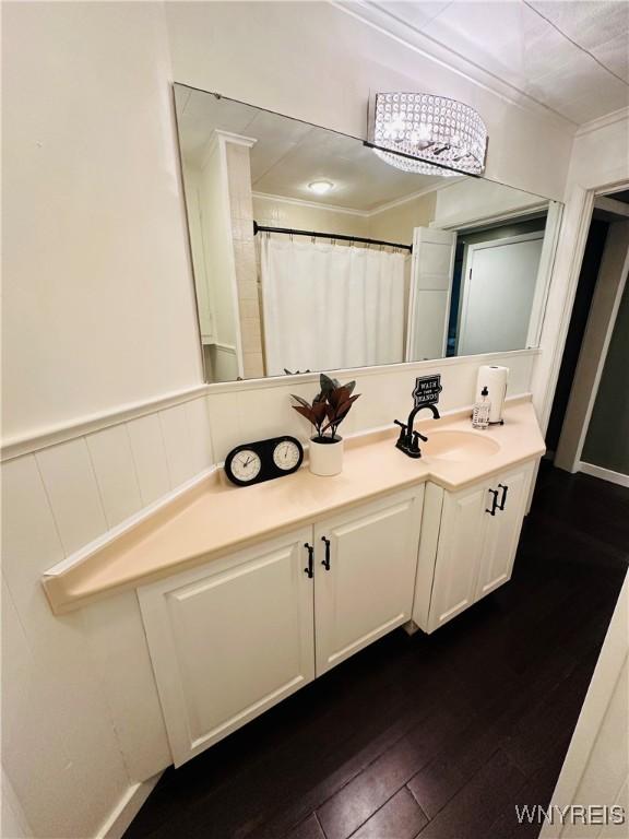 34 Maple St, Ellery, NY 14712 - bathroom featuring vanity, hardwood / wood-style flooring, crown molding, and a wainscoted wall