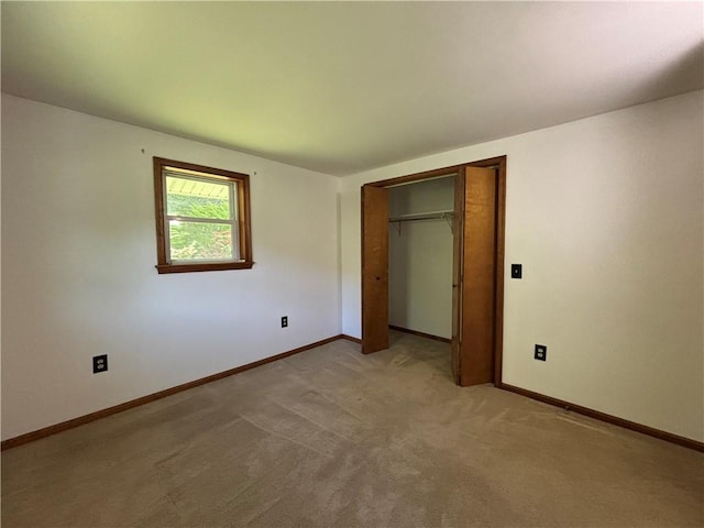 606 County Highway 12, Laurens, NY 13796 - unfurnished bedroom featuring baseboards, a closet, and light colored carpet