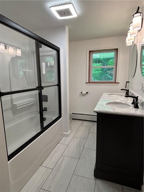 606 County Highway 12, Laurens, NY 13796 - bathroom featuring a baseboard radiator, double vanity, marble look tile flooring, shower / bath combination with glass door, and baseboards