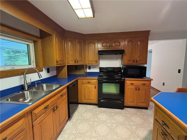 606 County Highway 12, Laurens, NY 13796 - kitchen featuring black appliances, a sink, under cabinet range hood, and brown cabinetry