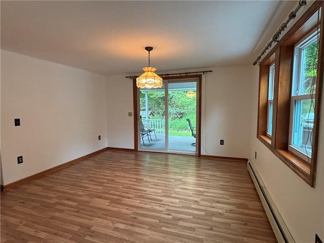 606 County Highway 12, Laurens, NY 13796 - unfurnished room featuring a baseboard radiator, wood finished floors, and baseboards