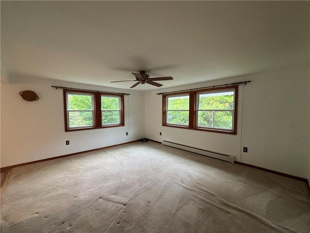 606 County Highway 12, Laurens, NY 13796 - carpeted empty room featuring a baseboard heating unit, ceiling fan, and baseboards