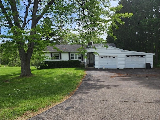 7650 Grant Avenue Rd, Sennett, NY 13021 - single story home with a front yard, driveway, a chimney, and a garage