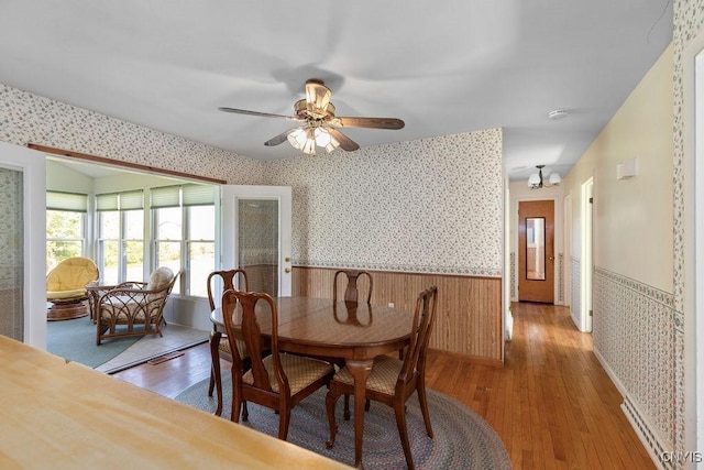 299 Sharp Rd, Granby, NY 13069 - dining room featuring wainscoting, light wood-style flooring, wallpapered walls, and ceiling fan