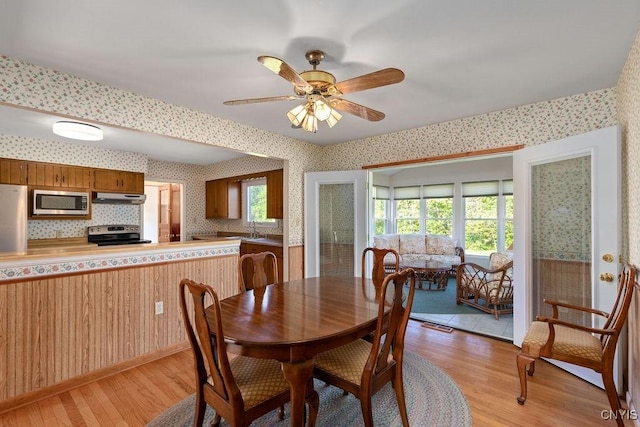 299 Sharp Rd, Granby, NY 13069 - dining area with wallpapered walls, light wood-style floors, and ceiling fan