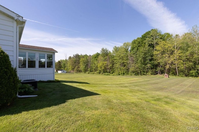 299 Sharp Rd, Granby, NY 13069 - view of grassy yard with central air condition unit and a view of trees