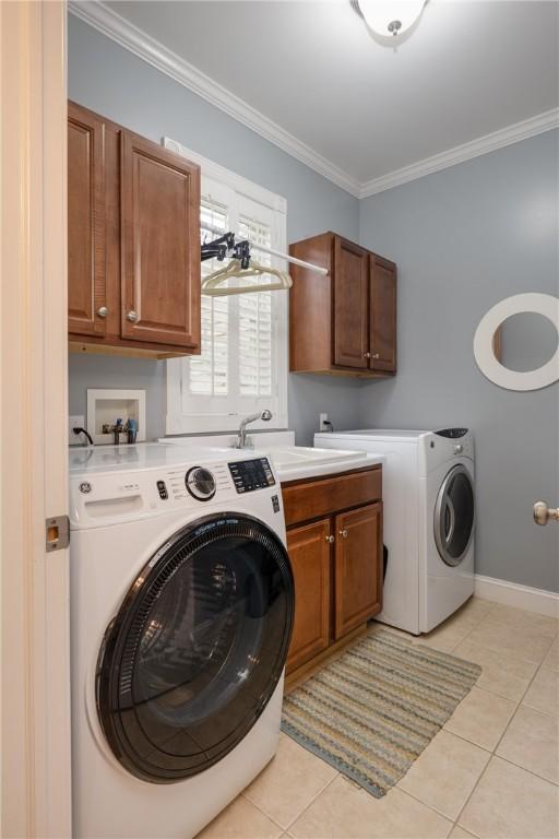 3104 Knoll Rd, Erwin, NY 14870 - washroom with cabinet space, washer and clothes dryer, light tile patterned flooring, crown molding, and baseboards