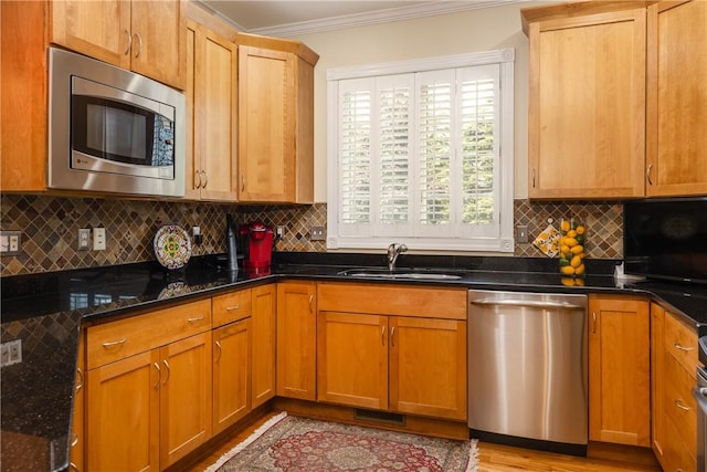 3104 Knoll Rd, Erwin, NY 14870 - kitchen featuring appliances with stainless steel finishes, a sink, ornamental molding, backsplash, and dark stone counters