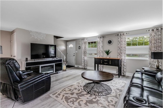 195 Robert Dr, North Tonawanda, NY 14120 - living area featuring light wood finished floors, stairs, and baseboards