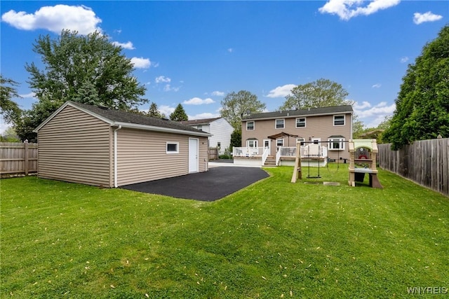 195 Robert Dr, North Tonawanda, NY 14120 - rear view of property featuring a deck, a patio, and an outbuilding
