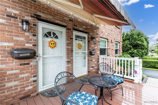 195 Robert Dr, North Tonawanda, NY 14120 - doorway to property with brick siding and covered porch