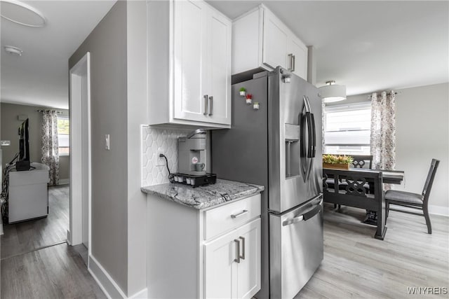 195 Robert Dr, North Tonawanda, NY 14120 - kitchen featuring stainless steel refrigerator with ice dispenser, light wood finished floors, baseboards, white cabinetry, and light stone counters