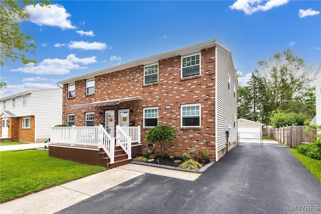 195 Robert Dr, North Tonawanda, NY 14120 - townhome / multi-family property with a front lawn, a detached garage, brick siding, and an outbuilding