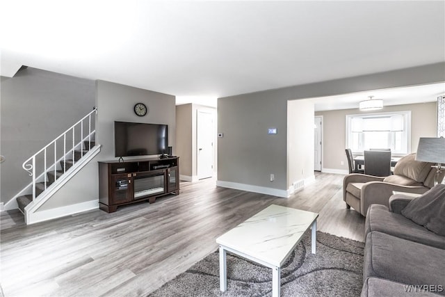 195 Robert Dr, North Tonawanda, NY 14120 - living room featuring stairway, wood finished floors, and baseboards