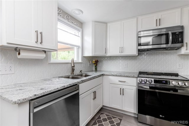 195 Robert Dr, North Tonawanda, NY 14120 - kitchen featuring appliances with stainless steel finishes, a sink, white cabinetry, and light stone counters
