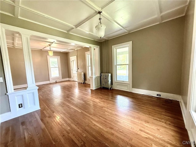 140 Maple St, Le Ray, NY 13612 - spare room featuring radiator, ornate columns, wood-type flooring, coffered ceiling, and baseboards