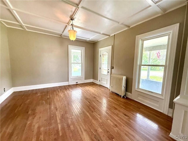 140 Maple St, Le Ray, NY 13612 - unfurnished room featuring radiator heating unit, wood-type flooring, coffered ceiling, and baseboards