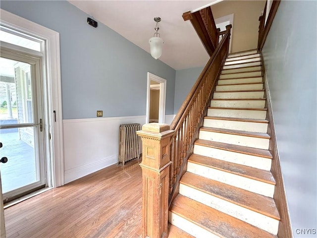 140 Maple St, Le Ray, NY 13612 - stairway with radiator, wood finished floors, and baseboards