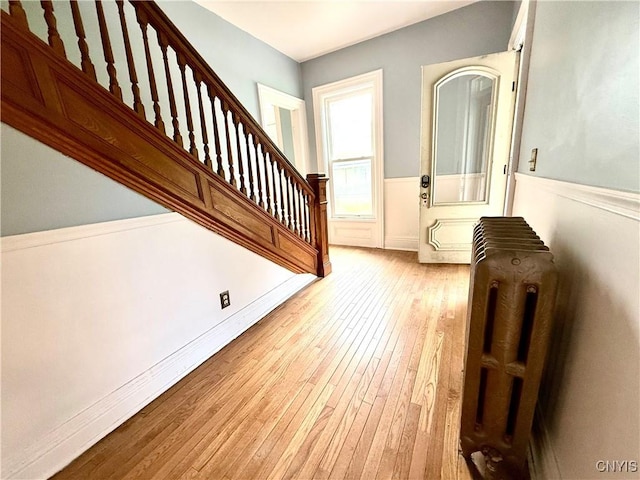 140 Maple St, Le Ray, NY 13612 - entrance foyer featuring stairway, a wainscoted wall, and wood-type flooring