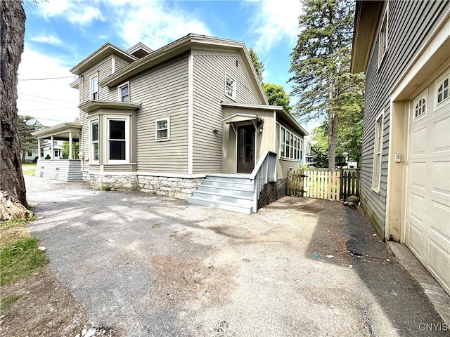 140 Maple St, Le Ray, NY 13612 - view of property exterior featuring a garage and driveway