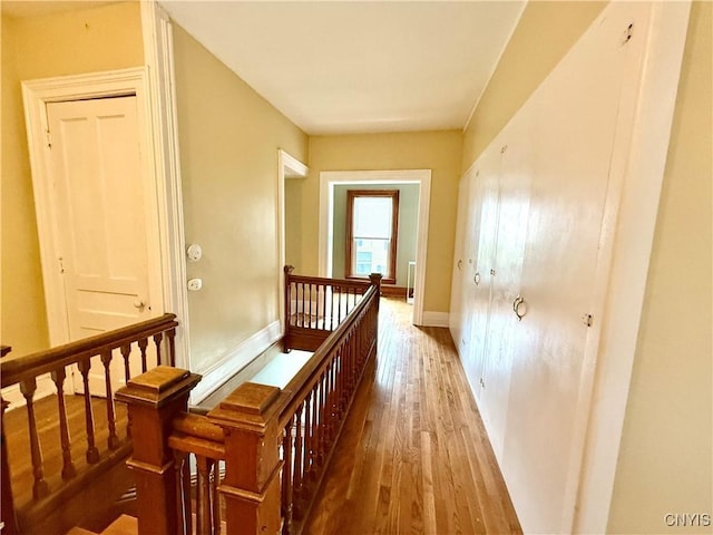 140 Maple St, Le Ray, NY 13612 - corridor featuring an upstairs landing, wood finished floors, and baseboards