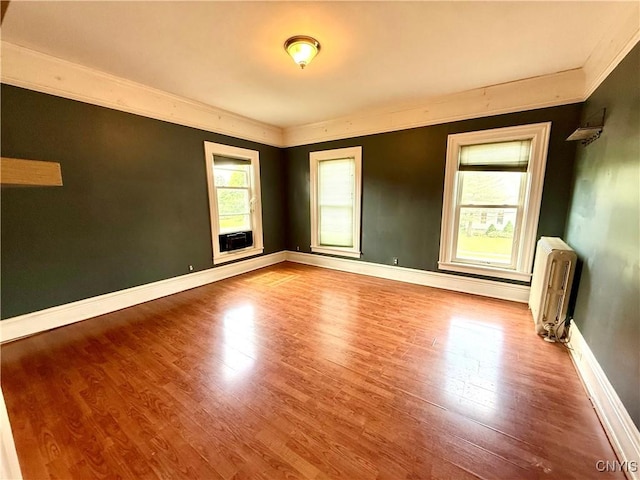 140 Maple St, Le Ray, NY 13612 - spare room with radiator heating unit, crown molding, wood finished floors, and baseboards