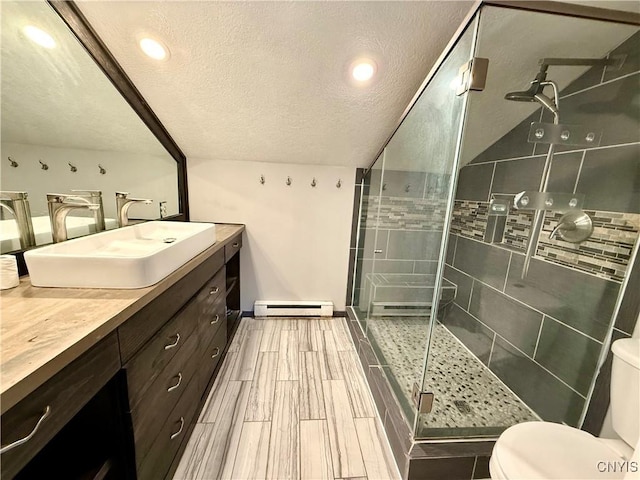 140 Maple St, Le Ray, NY 13612 - full bathroom featuring a baseboard radiator, vanity, toilet, a textured ceiling, and a shower stall