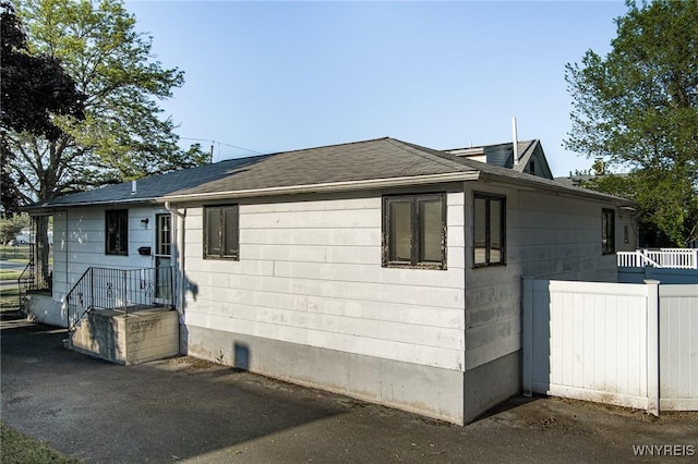 2923 N Ave, Niagara Falls, NY 14305 - view of home's exterior with a shingled roof and a patio area