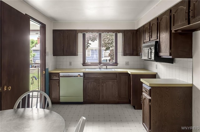 2923 N Ave, Niagara Falls, NY 14305 - kitchen with dishwasher, a sink, light flooring, black microwave, and dark brown cabinetry