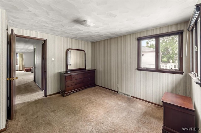 2923 N Ave, Niagara Falls, NY 14305 - unfurnished bedroom featuring carpet floors, wallpapered walls, and baseboards