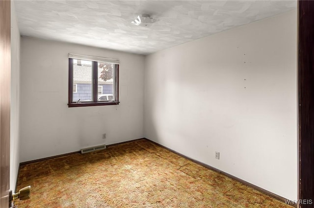 2923 N Ave, Niagara Falls, NY 14305 - carpeted empty room with a textured ceiling and baseboards