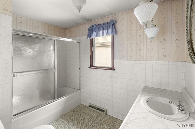 2923 N Ave, Niagara Falls, NY 14305 - full bath featuring wallpapered walls, enclosed tub / shower combo, tile walls, vanity, and tile patterned floors